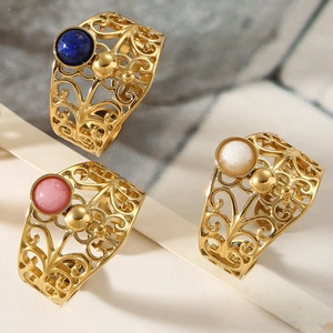 Detailed view of vintage gold hollowed rings with blue pink and white gemstones