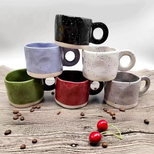 Irregular ceramic coffee mugs with splatter paint texture and unglazed base in various colors