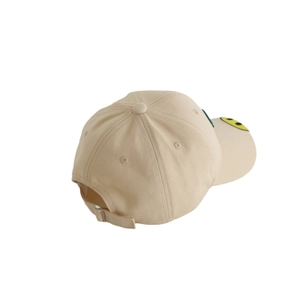 Beige cotton kids baseball cap with green embroidery and yellow smile on the brim