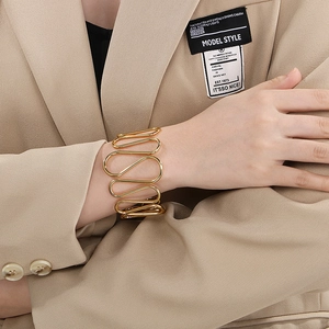 Irregular wavy gold open cuff bracelet in minimalist aesthetic for elegant women