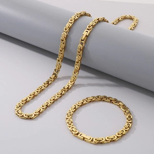 Polished gold 6mm flat Byzantine chain necklace and bracelet set for men on display