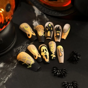 Halloween matte black press-on nails with orange gradient ghost and spider web designs