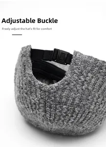 Close-up of adjustable black plastic buckle on grey knit hat for custom head circumference