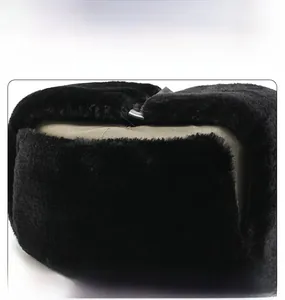 Detail shot of winter trapper hat showing thick black faux fur lining and khaki fabric