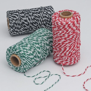 Close-up of three rolls of bicolor cotton baking twine for gift wrapping and DIY crafts
