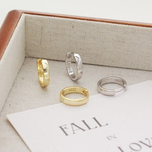 Detailed macro shot of S925 sterling silver hoop earrings in gold and silver finishes