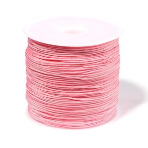 Macro detail of high-quality pink 0.8mm nylon cord roll for DIY jewelry making and weaving