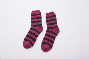 Close-up of soft striped coral fleece fabric in dark pink and black for men's cozy socks