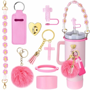 Pink Stanley cup accessory set with floral strap, glitter cross charm, and faux fur pompom