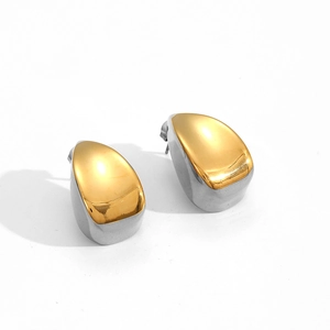 Detail of two-tone gold and silver drop earrings with polished pebble design