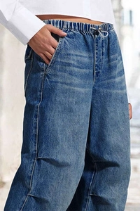Detail of blue high waist wide leg jeans with elastic drawstring and side pockets