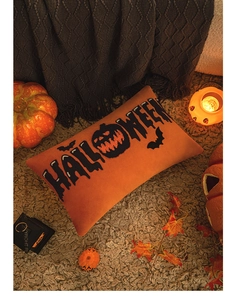 Detail of orange Halloween velvet pillow with black pumpkin and bat embroidery