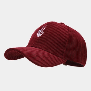 Close-up of burgundy corduroy baseball cap with white skeleton finger embroidery detail
