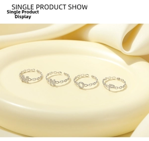 Macro view of S925 sterling silver hollow letter rings with diamonds on silk