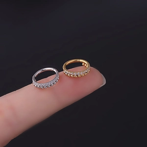 Pair of gold and silver seamless hinged piercing rings with tiny beads and zircons