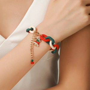 Wrist detail of Christmas resin chain bracelet with red and white rhinestone bell charm