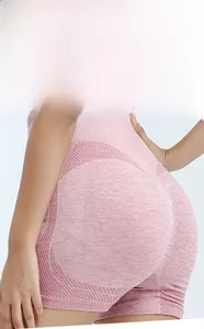 Detail of pink seamless high waisted yoga shorts with peach lift and honeycomb texture