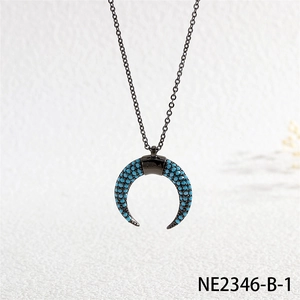Detail of black crescent moon pendant necklace with turquoise micro-inlay stones