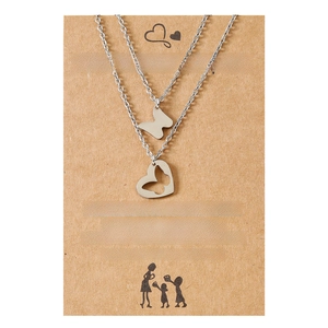 Silver mother daughter necklace set with butterfly heart pendants on kraft paper card