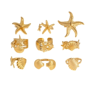 9-piece gold ocean ring set featuring starfish, shells, and scallops in a grid display