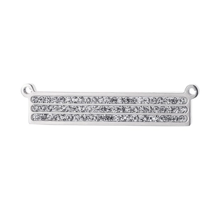 Close-up of geometric silver stainless steel pendant with three rows of clear crystals