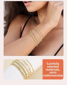 Close-up of five-piece gold layered bracelet set with cuban and paperclip chains