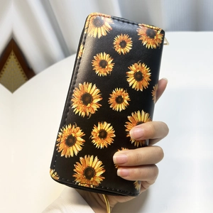 Detailed view of sunflower print on black PU leather wallet with a secure metal zipper