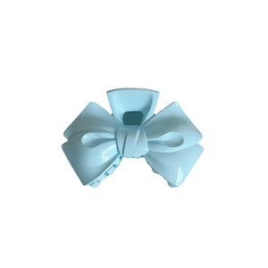 Light blue bow-shaped acrylic hair claw clip with a glossy finish for women
