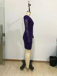 Detail of purple long sleeve bodycon dress featuring ruched mesh fabric texture