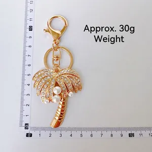 Creative coconut tree keychain with rhinestones and pearls on a golden alloy frame