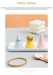 Pastel ceramic ring holder set with three conical stands and a white rectangular tray