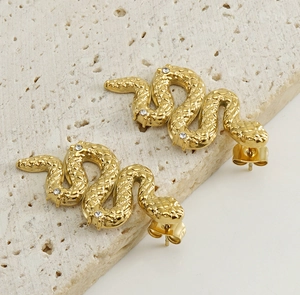 Macro shot of 18K gold-plated snake earrings with scale texture and white zircon stones