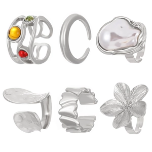 Detail of 6-piece silver ring set featuring baroque pearl, floral motifs and gemstones