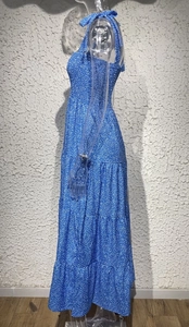 Detailed side view of a blue floral tiered maxi dress with ruched bodice and back tie