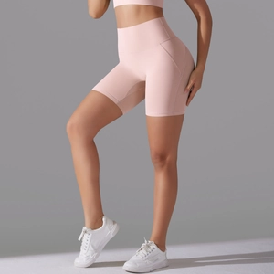 Detail of high-waisted pink fitness shorts with seamless front and supportive stitching