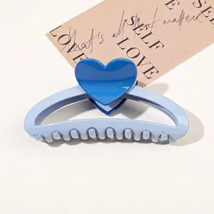 Close-up of heart pattern hair claw clip on vintage card background