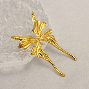 Macro shot of gold butterfly ear cuff featuring liquid metal style and textured wings