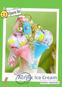 Detail of pink and blue acrylic ice cream keychains with floating liquid and golden metal clasp