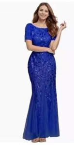 Detailed view of royal blue sequined lace fabric on a fitted mermaid evening gown