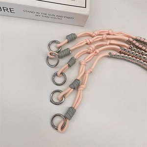 Detail of adjustable woven straps with silver metal rings in pink and grey colorway