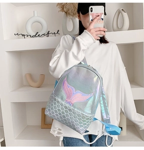 Macro detail of laser iridescent fabric and mermaid tail embroidery on stylish backpack