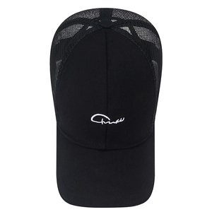 Classic black trucker hat with mesh back and white signature embroidery on front panel