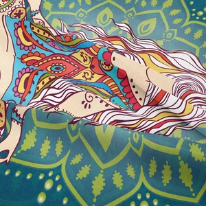 Close-up of bohemian mandala tapestry showing intricate fabric texture and vivid blue patterns