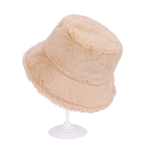 Detailed macro view of the soft faux fur texture on this stylish beige bucket hat for winter