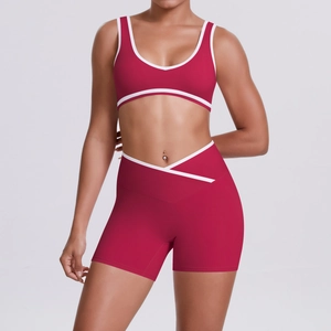 Detail of red workout set with contrast white piping and criss-cross waist design