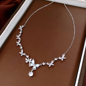 Detailed view of silver butterfly necklace with sparkling zircon and mother of pearl inlay