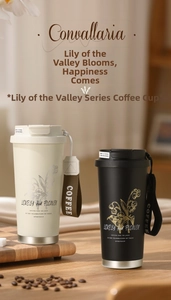 Close-up of matte lily of the valley coffee tumblers with stylish carrying straps