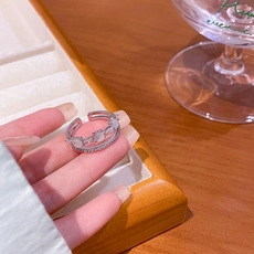 Detailed view of silver double-layer ring with moonstone and sparkling cubic zirconia