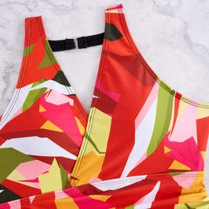 Detail of the cross V-neck and silver metal buckle on colorful printed tankini top