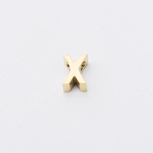 Detailed macro view of a 1.8mm gold-plated stainless steel letter X alphabet bead